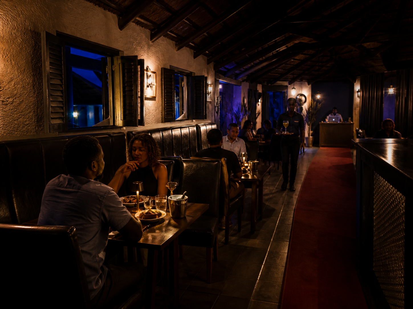 Warmly lit lounge interior with leather seating and blue ambient light